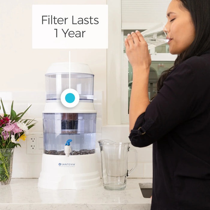 a woman standing in front of a water dispenser